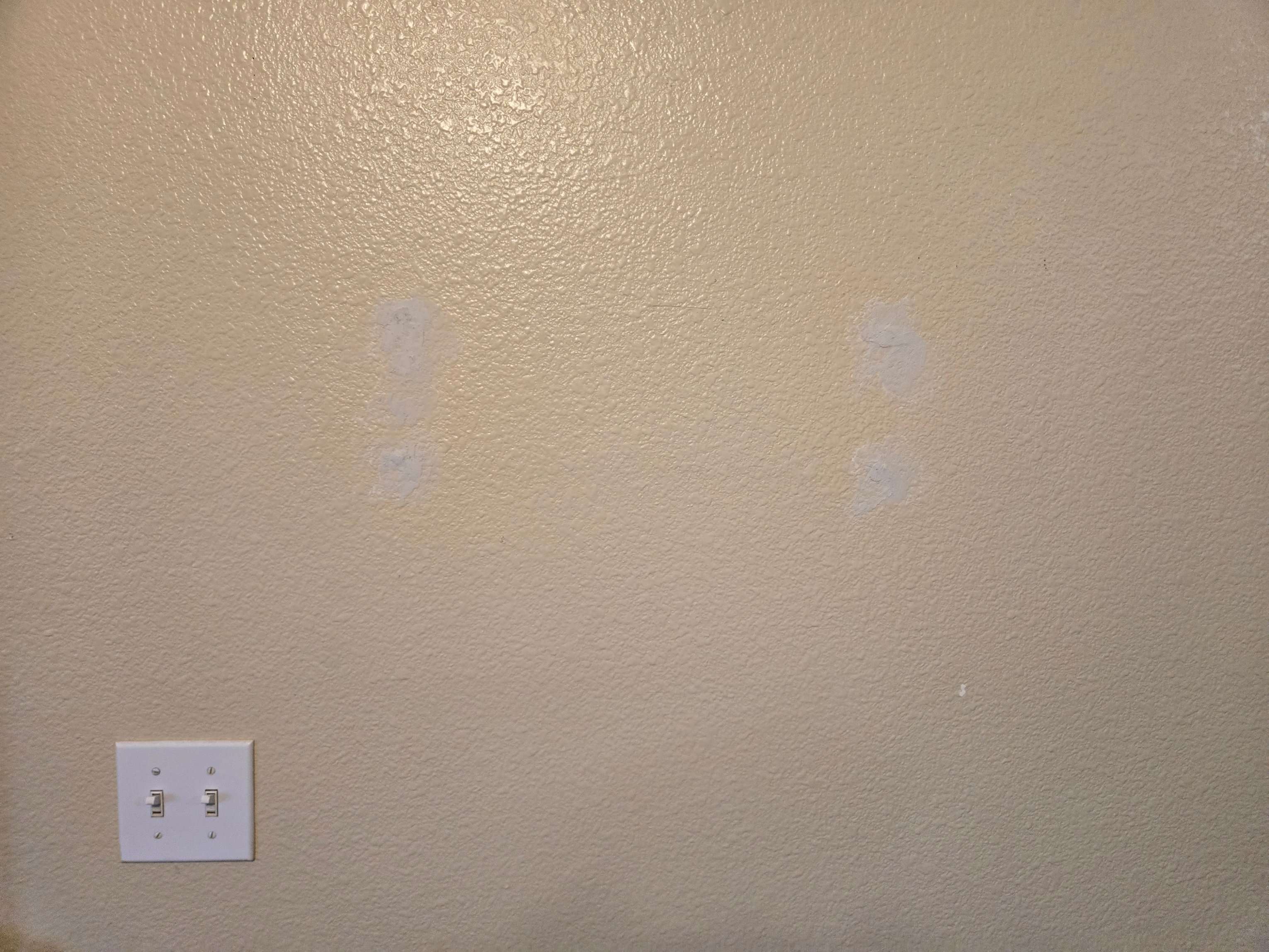 Wall with neatly patched holes from TV mount removal by Mount & Fix DFW