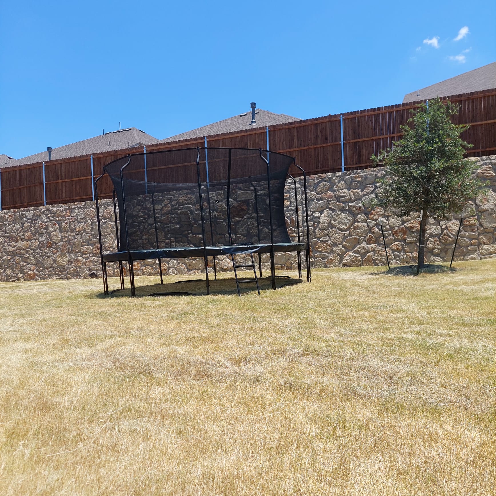 Partially assembled trampoline with safety net poles by Mount & Fix Dallas